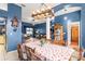Stylish dining area showcasing a decorative chandelier, dining table set, and an open-concept living space at 12040 Penzance Ln, New Port Richey, FL 34654
