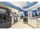 The kitchen features sleek appliances, including a stainless-steel refrigerator, with plenty of counter space at 12040 Penzance Ln, New Port Richey, FL 34654