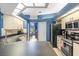 The kitchen features sleek appliances, including a stainless-steel refrigerator, with plenty of counter space at 12040 Penzance Ln, New Port Richey, FL 34654
