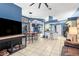 Open-concept living and dining area with tile flooring and a view of the kitchen at 12040 Penzance Ln, New Port Richey, FL 34654