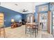 Versatile living space with tile floors, blue walls, a ceiling fan, and an eat-in kitchen area at 12040 Penzance Ln, New Port Richey, FL 34654