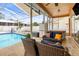 Relaxing covered lanai with comfortable seating next to a refreshing pool and spa at 12040 Penzance Ln, New Port Richey, FL 34654