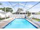 Inviting in-ground pool within a screened enclosure, providing a private outdoor oasis for recreation and relaxation at 12040 Penzance Ln, New Port Richey, FL 34654