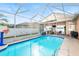 Refreshing screened in pool, ideal for outdoor enjoyment and leisure, and perfect for cooling off on warm days at 12040 Penzance Ln, New Port Richey, FL 34654