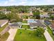 Aerial view of a property showcasing a backyard pool, well-manicured lawn, and a three-car garage at 13052 Drysdale St, Spring Hill, FL 34609
