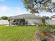 Backyard featuring a covered patio and chain link fence with garden at 13052 Drysdale St, Spring Hill, FL 34609