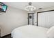 Cozy bedroom with a queen bed, modern ceiling fan, dark trim, and closet with white doors at 13052 Drysdale St, Spring Hill, FL 34609