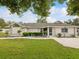 Charming single-story home with well-manicured lawn and beautiful landscaping at 13052 Drysdale St, Spring Hill, FL 34609