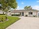 Charming single-story home with well-manicured lawn and beautiful landscaping at 13052 Drysdale St, Spring Hill, FL 34609