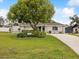 Well-maintained front yard with mature trees and landscaping, enhancing the home's curb appeal at 13052 Drysdale St, Spring Hill, FL 34609
