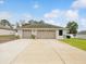 Three-car garage with ample parking space and potential for storage or workshop area at 13052 Drysdale St, Spring Hill, FL 34609