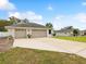 Spacious three-car garage with a wide driveway and well-maintained exterior at 13052 Drysdale St, Spring Hill, FL 34609