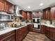 Well-equipped kitchen with stainless hood, cooktop, and double ovens at 13052 Drysdale St, Spring Hill, FL 34609