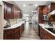 Kitchen featuring stainless steel appliances, wood cabinetry, and tile backsplash at 13052 Drysdale St, Spring Hill, FL 34609