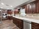 Kitchen with abundant cabinets, stainless appliances, backsplash and white countertops at 13052 Drysdale St, Spring Hill, FL 34609