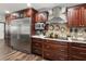 Gourmet kitchen with stainless steel appliances and wooden cabinetry at 13052 Drysdale St, Spring Hill, FL 34609
