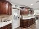 Open kitchen featuring wood cabinets, stainless steel appliances, and white countertops at 13052 Drysdale St, Spring Hill, FL 34609