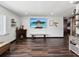 Bright living room with wood-look flooring, fireplace and a wall-mounted TV for entertainment at 13052 Drysdale St, Spring Hill, FL 34609