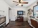 Bright office space with built-in storage and shelving, a ceiling fan, and wood-look floors at 13052 Drysdale St, Spring Hill, FL 34609