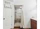 Walk-in shower with decorative tile, shelving, and curtain at 13052 Drysdale St, Spring Hill, FL 34609