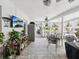 Enclosed sun room with tile floors, ceiling fans, white curtains, furniture, plants, tv and a backyard view at 13052 Drysdale St, Spring Hill, FL 34609