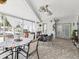 Enclosed sun room with tile floors, ceiling fans, furniture, white curtains, and backyard view at 13052 Drysdale St, Spring Hill, FL 34609