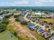 Aerial perspective of the property with stunning views of the neighborhood, a tranquil pond, and verdant landscaping at 13618 Niti Dr, Hudson, FL 34669