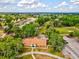 Aerial view of Meadow Oaks Golf & Country Club clubhouse, parking and lush landscaping at 13618 Niti Dr, Hudson, FL 34669