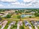 Aerial shot highlighting the home's location near a scenic pond and golf course, offering a picturesque community setting at 13618 Niti Dr, Hudson, FL 34669