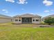 Backyard view showcases the home's exterior and well-maintained lawn at 13618 Niti Dr, Hudson, FL 34669