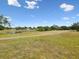 Beautiful backyard view overlooking a tranquil pond and a meandering path, enhancing the property's serene setting at 13618 Niti Dr, Hudson, FL 34669
