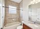 Tiled bathroom featuring a granite-topped vanity, a tub, and updated fixtures at 13618 Niti Dr, Hudson, FL 34669