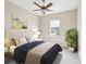 Comfortable bedroom featuring neutral decor, a ceiling fan, a large window, and stylish accents at 13618 Niti Dr, Hudson, FL 34669