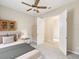 Inviting bedroom with ceiling fan and view through open doorway, creating a sense of spaciousness at 13618 Niti Dr, Hudson, FL 34669