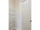 A small walk in closet with white wire shelving for storage at 13618 Niti Dr, Hudson, FL 34669