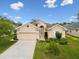 Charming single-story home with a well-manicured lawn and an attached two-car garage at 13618 Niti Dr, Hudson, FL 34669
