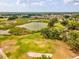 Picture of the golf course featuring lush greenery, mature trees, and a tranquil pond at 13618 Niti Dr, Hudson, FL 34669