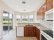 Bright kitchen with granite countertops, a breakfast bar, and views of the outdoors at 13618 Niti Dr, Hudson, FL 34669