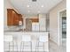 Bright kitchen with stainless appliances, tile flooring, granite countertops, breakfast bar and modern white chairs at 13618 Niti Dr, Hudson, FL 34669