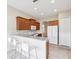 Modern kitchen featuring a breakfast bar, stainless steel appliances, and ample cabinet space at 13618 Niti Dr, Hudson, FL 34669