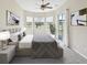 Serene main bedroom with bay windows, a ceiling fan, and a sliding glass door leading to outdoor area at 13618 Niti Dr, Hudson, FL 34669