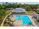 Aerial view of a community pool and recreation area with lounge chairs and well-maintained landscaping at 13618 Niti Dr, Hudson, FL 34669