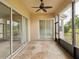 Open screened patio features sliding glass doors and decorative concrete flooring at 13618 Niti Dr, Hudson, FL 34669