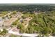 An aerial view shows a sprawling neighborhood with mature trees and well-maintained homes at 14545 Battenwood Dr, Spring Hill, FL 34610