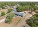 Birds eye view features the home, large backyard and surrounding area with mature trees at 14545 Battenwood Dr, Spring Hill, FL 34610