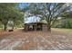 Outdoor barn area with open sides, suitable for storage of lawn equipment or use as a workshop at 14545 Battenwood Dr, Spring Hill, FL 34610