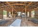 Open barn interior with wooden beams, providing ample space for storage and projects at 14545 Battenwood Dr, Spring Hill, FL 34610