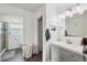 Bathroom with white cabinets, gray floor, updated vanity, and glass shower at 14545 Battenwood Dr, Spring Hill, FL 34610