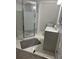Bathroom with glass shower, gray floor mat and vanity with sink at 14545 Battenwood Dr, Spring Hill, FL 34610