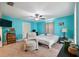 Bright bedroom with blue walls, neutral carpet, ceiling fan and dresser at 14545 Battenwood Dr, Spring Hill, FL 34610